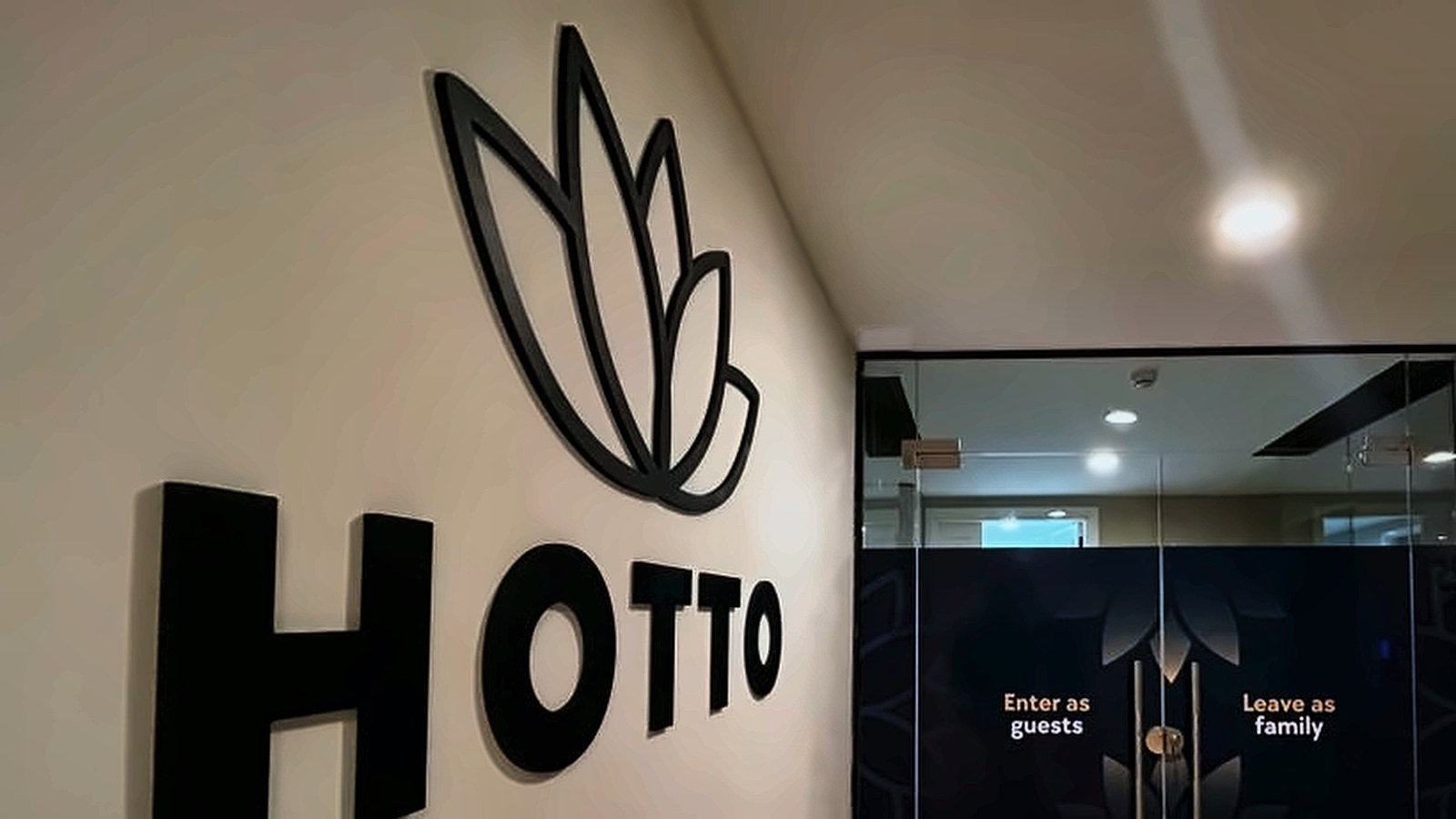 Hotto entrance with dimensional logo and glass doors