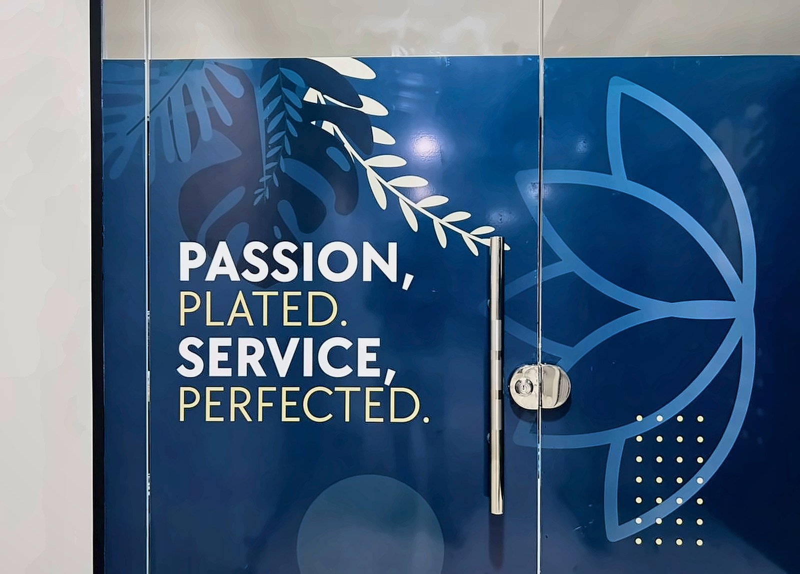 Installed glass graphic reading Passion, plated. Service, perfected.