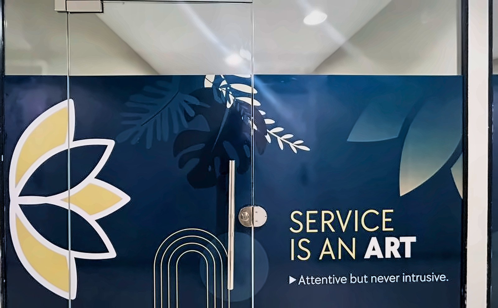 Installed Service Is An Art glass graphic with lotus and gold arch